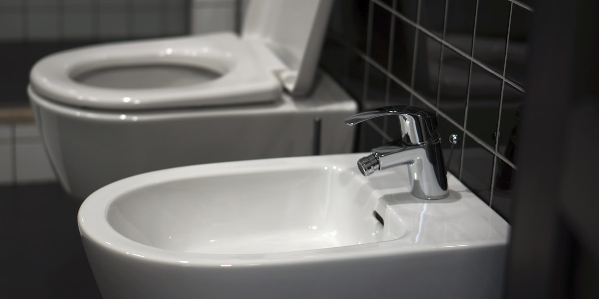 Modern bathroom with white fixtures including toilet and sink